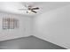 Bright bedroom is accented by a ceiling fan and window at 541 W Vernon Ave, Phoenix, AZ 85003