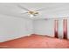 Spacious bedroom with neutral walls, red carpet and a ceiling fan at 541 W Vernon Ave, Phoenix, AZ 85003