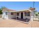 Inviting exterior with a shaded porch, decorative ironwork, and well-maintained landscaping at 541 W Vernon Ave, Phoenix, AZ 85003