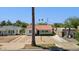 Charming white home featuring drought-resistant landscaping, an orange tiled roof, and a paved driveway and walkway at 541 W Vernon Ave, Phoenix, AZ 85003