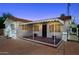 Charming single-story home featuring a red brick driveway and a covered porch with decorative flower pots at 541 W Vernon Ave, Phoenix, AZ 85003