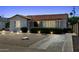 Inviting home with manicured landscaping, highlighted by landscape lighting and a charming clay tile roof at 541 W Vernon Ave, Phoenix, AZ 85003