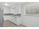 White kitchen featuring modern tile backsplash, white cabinetry, and stainless steel sink at 541 W Vernon Ave, Phoenix, AZ 85003