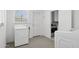 Bright laundry room featuring a washer, dryer, and convenient access to other parts of the house at 541 W Vernon Ave, Phoenix, AZ 85003