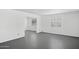 Minimalist living room offers neutral paint, window coverings and sleek concrete flooring at 541 W Vernon Ave, Phoenix, AZ 85003