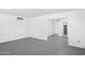 Spacious living room with white walls and gray flooring leading to other rooms at 541 W Vernon Ave, Phoenix, AZ 85003