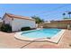 Beautiful backyard pool with a charming pool house and a surrounding brick patio at 541 W Vernon Ave, Phoenix, AZ 85003
