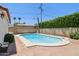 Backyard pool surrounded by a brick patio and lush green landscaping, perfect for relaxation at 541 W Vernon Ave, Phoenix, AZ 85003