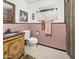 Retro bathroom with pink tile, decorative sink, and patterned shower curtain at 55 E Pierson St, Phoenix, AZ 85012