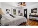 Well-lit bedroom features wooden floors, ceiling fan, and decorative artwork at 55 E Pierson St, Phoenix, AZ 85012