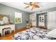 Comfortable bedroom with hardwood floors, vintage desk, and a ceiling fan at 55 E Pierson St, Phoenix, AZ 85012