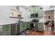 Charming kitchen with stainless steel appliances, light green cabinets, and white countertops at 55 E Pierson St, Phoenix, AZ 85012