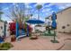 Relaxing patio area with a blue swing, comfortable seating, and lush greenery at 55 E Pierson St, Phoenix, AZ 85012