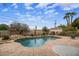 Inviting backyard pool with rock waterfall feature and desert landscaping, perfect for outdoor relaxation at 55 E Pierson St, Phoenix, AZ 85012