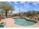 Backyard swimming pool with stone patio, rock features, desert plants, and fenced perimeter at 55 E Pierson St, Phoenix, AZ 85012