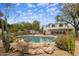 Refreshing pool with desert landscaping, a rock surround and fenced for privacy at 55 E Pierson St, Phoenix, AZ 85012