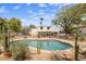 Inviting pool surrounded by desert landscaping, rock features and a fenced yard at 55 E Pierson St, Phoenix, AZ 85012