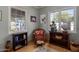 Cozy sitting area features a wicker chair, bookshelves, and natural light from two windows at 55 E Pierson St, Phoenix, AZ 85012