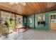 Sunroom with tile floors, a wood ceiling and a view of the lush backyard at 55 E Pierson St, Phoenix, AZ 85012