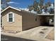 Single-story home with a covered parking area and a long concrete driveway at 625 W Mckellips Rd # 236, Mesa, AZ 85201