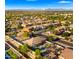 Wide aerial image of homes in a planned community, with green spaces and a golf green at 6602 S Constellation Way, Gilbert, AZ 85298
