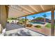 Inviting backyard with a covered patio area and a sparkling pool surrounded by lush landscaping at 6602 S Constellation Way, Gilbert, AZ 85298