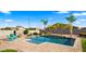 Inviting pool area with a sparkling pool, palm trees, and comfortable seating for relaxation at 6602 S Constellation Way, Gilbert, AZ 85298