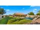Expansive backyard featuring a sparkling pool, a covered patio, and a lush lawn at 6602 S Constellation Way, Gilbert, AZ 85298