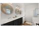Modern bathroom featuring double sinks, stylish mirrors, and shiplap wall accents at 6602 S Constellation Way, Gilbert, AZ 85298