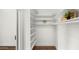 Well-organized walk-in closet featuring custom shelving and ample storage space at 6602 S Constellation Way, Gilbert, AZ 85298