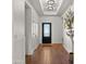 Hallway with a black front door and warm hardwood flooring at 6602 S Constellation Way, Gilbert, AZ 85298