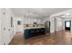 Bright kitchen with an island, pendant lighting, stainless steel appliances, and hardwood floors at 6602 S Constellation Way, Gilbert, AZ 85298