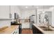 Modern kitchen with stainless steel appliances, white cabinets, and granite countertops at 6602 S Constellation Way, Gilbert, AZ 85298