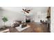 Open-concept living area boasts wood floors, a stone fireplace, and seamlessly connects to the kitchen, perfect for modern living at 6602 S Constellation Way, Gilbert, AZ 85298