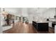 Open-concept living space featuring a kitchen with an island, a fireplace, and hardwood floors at 6602 S Constellation Way, Gilbert, AZ 85298