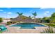 Sparkling pool with palm trees and lush landscaping create a backyard oasis for relaxation and entertainment at 6602 S Constellation Way, Gilbert, AZ 85298