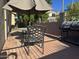 Charming back patio offers a serene space for dining under the umbrella and a BBQ at 6631 E Rhodes St, Mesa, AZ 85215
