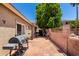 Backyard patio with barbecue grill, patio furniture and dog house at 6631 E Rhodes St, Mesa, AZ 85215