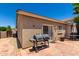 Back patio with a barbecue grill, outdoor seating, and a sliding door at 6631 E Rhodes St, Mesa, AZ 85215