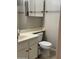 Bathroom features toilet, sink, vanity, mirror and combination tub and shower with glass doors at 6631 E Rhodes St, Mesa, AZ 85215