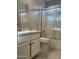 Clean bathroom with a white vanity, white tiled shower, and modern fixtures at 6631 E Rhodes St, Mesa, AZ 85215