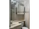 Bathroom features toilet, sink, vanity, mirror and combination tub and shower with glass doors at 6631 E Rhodes St, Mesa, AZ 85215