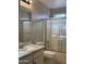 Standard bathroom with a sink, toilet, and shower and tub combo with glass doors at 6631 E Rhodes St, Mesa, AZ 85215