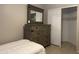 Cozy bedroom with dresser and mirror and a walk-in closet at 6631 E Rhodes St, Mesa, AZ 85215