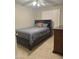 Bedroom with a queen-sized bed, tile floors, a ceiling fan and shuttered windows at 6631 E Rhodes St, Mesa, AZ 85215