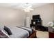 Bedroom with tiled floor, dark wood furniture, ceiling fan, and neutral walls creating a modern space at 6631 E Rhodes St, Mesa, AZ 85215