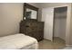 Cozy bedroom with dresser and mirror and a walk-in closet at 6631 E Rhodes St, Mesa, AZ 85215