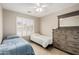 Cozy bedroom with neutral walls, tiled floor, twin beds, shutters, ceiling fan and a dresser with mirror at 6631 E Rhodes St, Mesa, AZ 85215
