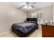 Bedroom with tiled floor, fan, built-in headboard, and a large window with shutter providing natural light at 6631 E Rhodes St, Mesa, AZ 85215