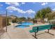 A community pool and spa are surrounded by green vegetation and mature trees at 6631 E Rhodes St, Mesa, AZ 85215